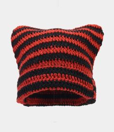 a red and black striped pillow sitting on top of a white wall