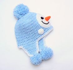 a blue knitted hat with a snowman on it