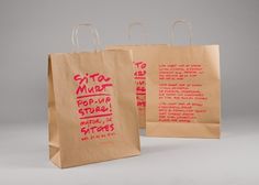 two brown paper bags with red writing on the front and back, each bag has a different message