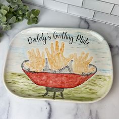 a plate with some food on it and a plant in the background that says daddy's grilling plate