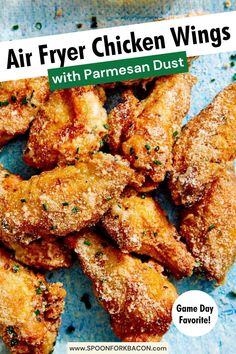 some fried chicken wings with parmesan dust are on a blue plate and the words, air fryer chicken wings with parmesan dust