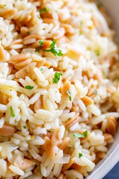 a bowl filled with rice and nuts on top of a table