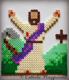 the beaded jesus is holding his arms up in front of him and two other beads