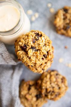 three oatmeal cookies next to a glass of milk