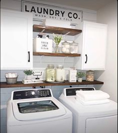 a washer and dryer in a laundry room with shelves above the washer