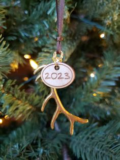 a wooden ornament hanging from a christmas tree