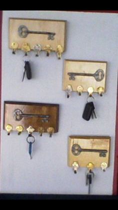 several keys are hanging on the wall with key hooks