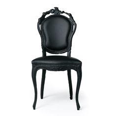 a black chair with an ornate back and seat