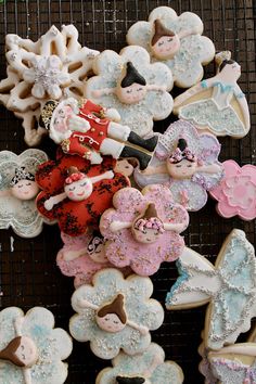 several decorated cookies on a cooling rack with snowflakes and angel figurines