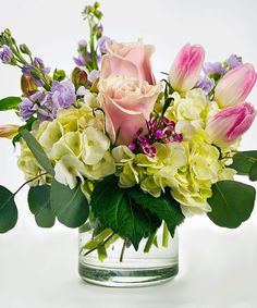 a vase filled with lots of flowers on top of a table