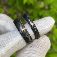 Gorgeous His & Her Damascus Ring Set. The Men's Ring is 6mm wide with a 1 millimeter vertical 14k rose gold inlay and the women's ring is 4mm wide with a 1 millimeter 14k rose gold inlay. Each ring is made to order by some of the best jewelry artisans that the industry has to offer. Our Damascus steel rings have an inside comfort fit to ensure that the ring will rest comfortably on your finger throughout the day and fits perfectly. This uniquely styled ring also has a two-tone finish with a Rings His And Hers, Black Anniversary Rings With Engraving Option, Black Jewelry With Engraving Option For Anniversary, Adjustable Carved Rings For Anniversary, Black Etched Rings For Anniversary, Black Etched Rings As A Gift, Anniversary Black Etched Rings, Damascus Steel Wedding Band, His And Her Wedding Rings