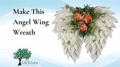 an angel wing wreath with roses and greenery on it is featured against a blue background