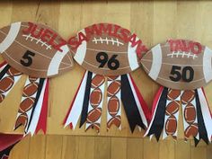 three paper plates with footballs on them and ribbons in the shape of numbers for each team