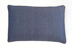 a blue pillow on a white surface with lines drawn across the front and back of it