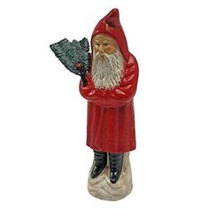 a gnome figurine holding a pine cone in his hand and wearing a red coat