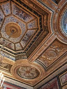 an ornate ceiling in a building with paintings on it