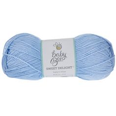 a blue ball of yarn with the words baby bee sweet delight on it's side