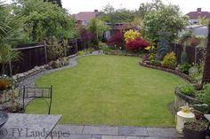 a garden with grass and flowers in it