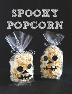 two bags with popcorn in them and the words spooky popcorn written on it