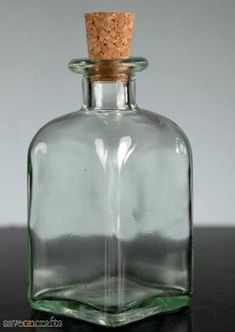 an empty glass bottle with a cork top