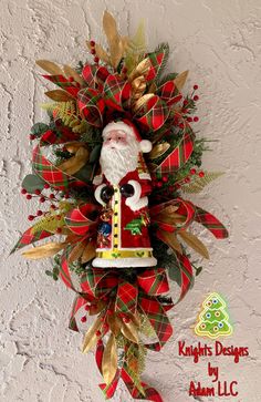 a christmas wreath hanging on the side of a wall with a santa clause figure attached to it