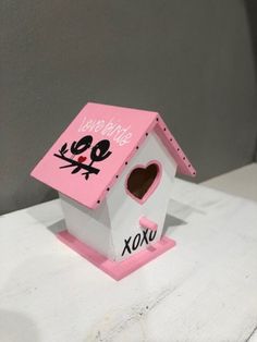 a pink and white birdhouse with a heart on it's roof that says happy birthday xoxo