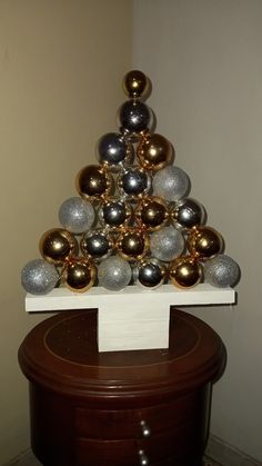 a christmas tree made out of balls on top of a table