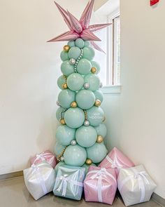 a christmas tree made out of balloons and presents