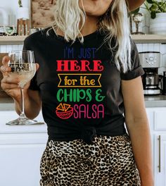 This "I'm Just Here For The Chips & Salsa" design is the perfect, fun Cinco De Mayo shirt for anyone that loves drinks and to celebrate! Fun T-shirt With Funny Text For Parties, Multicolor Letter Print Tops For Party, Cinco De Mayo Funny Print Crew Neck Top, Fun Graphic Print T-shirt For Cinco De Mayo, Funny Print Party Tops, Funny Text Tops For Party, Multicolor Letter Print Tops For Cinco De Mayo, Fun Cinco De Mayo Crew Neck T-shirt, Cinco De Mayo Fun Crew Neck T-shirt