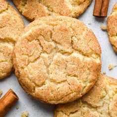 cinnamon sugar cookies on a baking sheet with cinnamon sticks