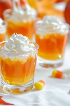 small desserts with whipped cream and candy corn on the side, sitting on a table