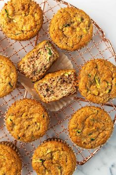 zucchini muffins cooling on a wire rack with other muffins