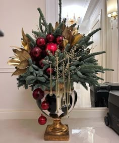 a vase filled with christmas decorations on top of a counter