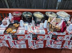 an outdoor picnic table with food on it