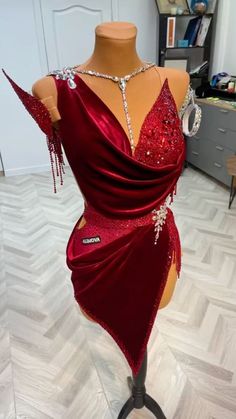 a mannequin wearing a red dress with sequins on it's back