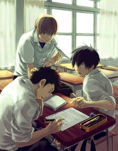 three people sitting at a desk with papers and pens