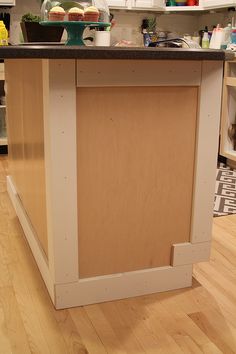 the kitchen island is made out of plywood and has no cabinet doors or drawers