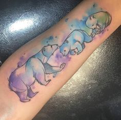 an elephant family tattoo on the arm