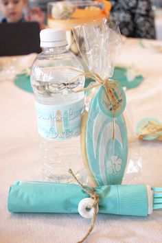 a bottle of water sitting on top of a table next to a napkin and bag