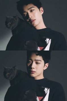 a man holding a black cat in his arms