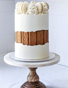 a cake with white frosting and cookies on top