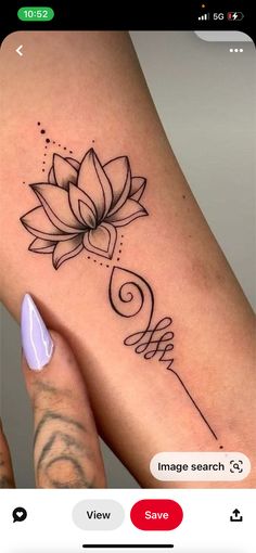 a woman's arm with a flower tattoo on it