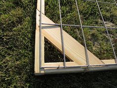 a metal and wood frame laying in the grass