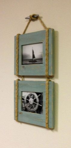 two framed pictures hanging on the wall with rope and twine around them, one has a sailboat in it