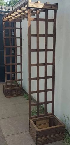 two wooden planters sitting on the side of a building