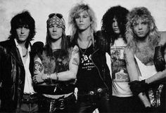 the group of punk rockers posing for a black and white photo