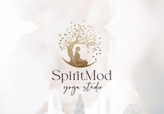 the logo for spiritmod yoga studio is displayed on a blurry background with candles and figurines