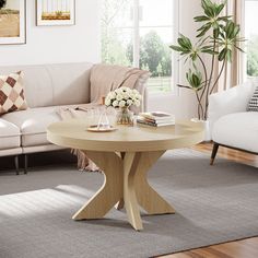 a living room filled with furniture and a wooden table in front of a white couch