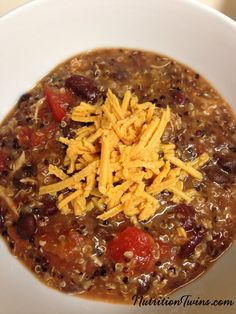 a white bowl filled with chili and cheese