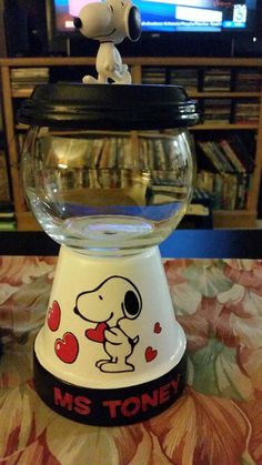 a glass bowl with a snoopy dog on it and the words ms tone written in red